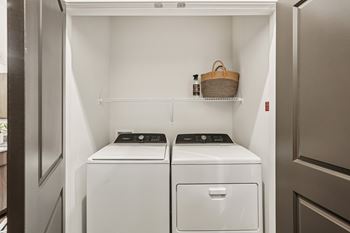 A small laundry room with a washer and dryer